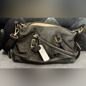 New, never used charcoal gray medium sized purse with gold trim.